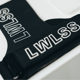 Close-up of a black strap or band with bold white outlined text reading 'LWLSS' on a white surface.